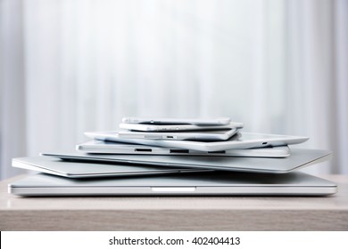 Stack Of Electronic Device On Wooden Table