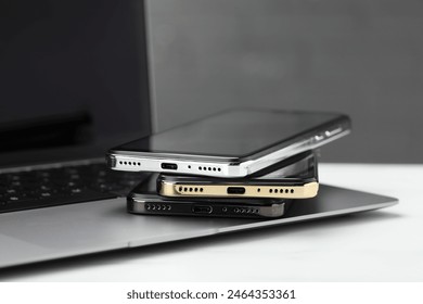 Stack of electronic devices on white table