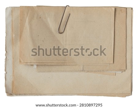 Stack of empty aged vintage paper documents with envelope and paper clip isolated on white
