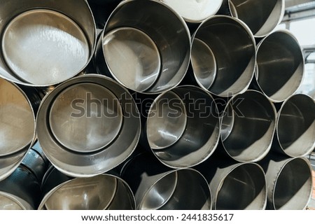 stack of empty artillery metal shells in factory