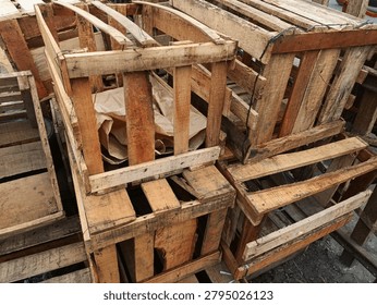 Stack of empty handmade wooden crates used for shipping and fruit packaging