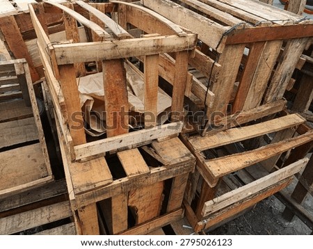 Stack of empty handmade wooden crates used for shipping and fruit packaging
