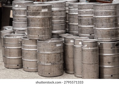Stack of Empty Metal Beer Kegs in Outdoor Storage Area