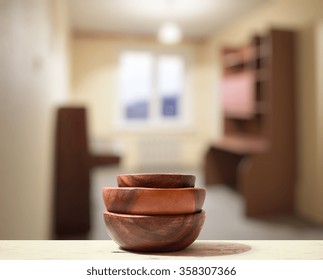 stack of empty wooden bowls old white table in the living room