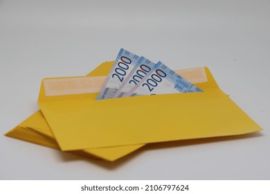 A stack of envelopes. Close-up with an envelope full of euro banknotes on a light background. The concept of corruption and bribery
