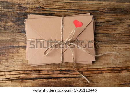Stack of envelopes on wooden table, top view. Love letters
