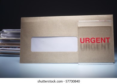 Stack of envelopes with urgent sign.