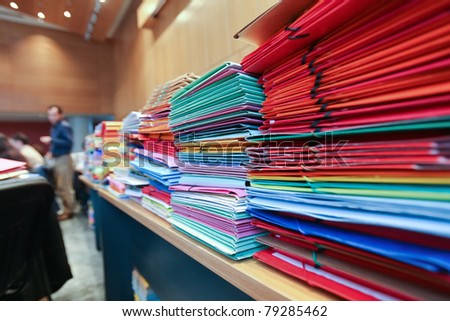 stack of envelops on desks and chairs