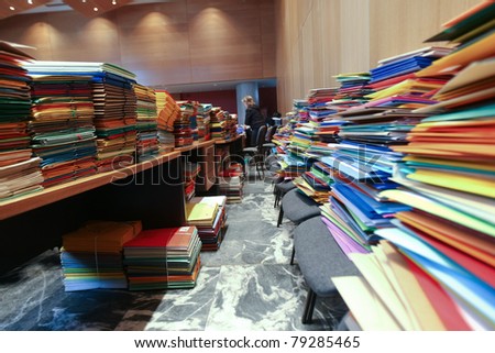 stack of envelops on desks and chairs