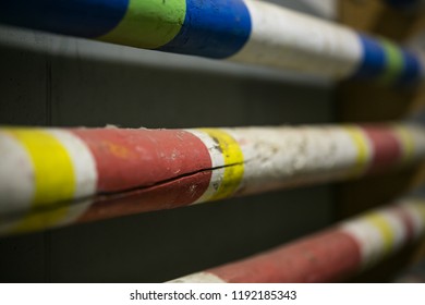 Stack of equestrian jumping poles in various colors - Shutterstock ID 1192185343
