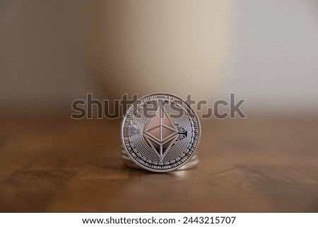 Stack of ether coins or ethereum on silver background to illustrate blockchain and cyber currency.