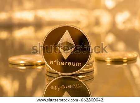 Stack of ether coins or ethereum on gold background to illustrate blockchain and cyber currency