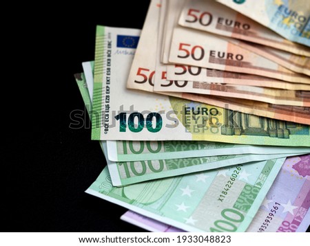 Stack of euro banknotes on black background