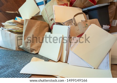 Stack of file folders, paperwork and papers ready for recycling