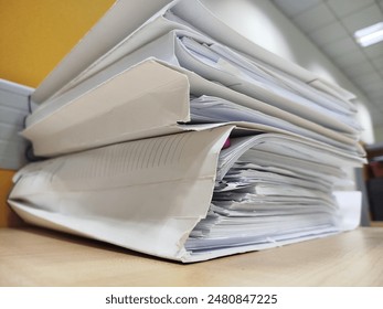 Stack of files, stack of papers, stack of thick files.