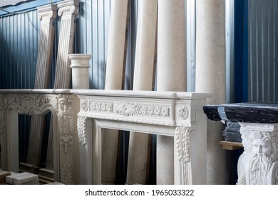 Stack of fireplace parts and decorative elements in warehouse or workshop, indoor shot