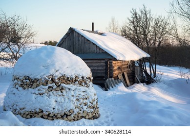 Stack Of Firewood Against Russian Traditional Banya.