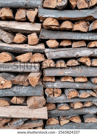 Stack of firewood, wood logs texture background. Pile of chopped fire wood prepared for winter.
