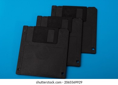 Stack of floppy disks over blue background