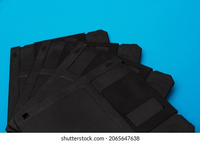 Stack of floppy disks over blue background