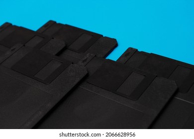 Stack of floppy disks over blue background