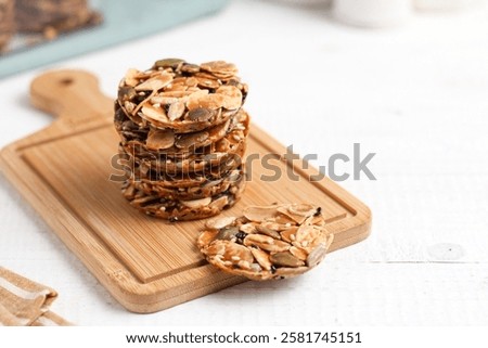 A stack of Florentine cookies. Eid al-Fitr cookies. Made from sugar and various nuts and seeds. Perfect for recipe, article, catalogue, or any commercial purposes.