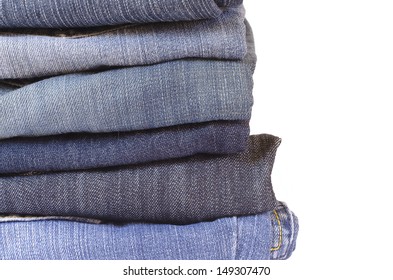 Stack Of Folded Jeans On White Background