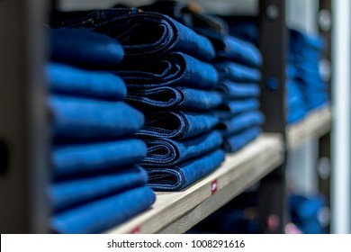 stack of folded jeans in the store
