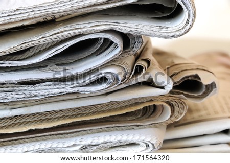 stack of folded newspapers