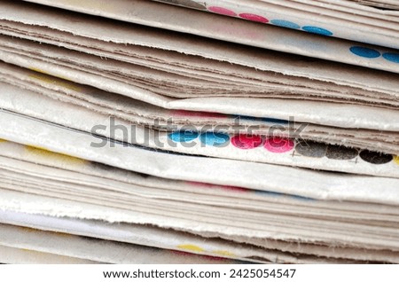 Stack of folded newspapers, background. Pile of newspapers as a background. News in the form of fresh newspapers, background, texture.