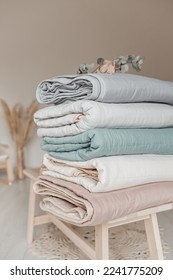 Stack of folded warm blankets with different design patterns. cotton blankets. Close up view of hypoallergenic Cotton bedding.