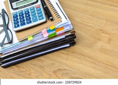 stack of folders and documents on office desk