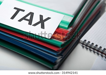 stack of folders and metaphor for the payment of taxes