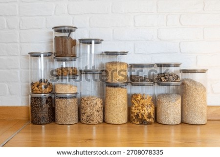 A stack of food storage containers filled with spices and grains