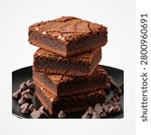 Stack of four chocolate brownies with chocolate chips on black plate