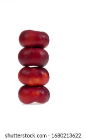 Stack of four flat nectarines isolated on white
