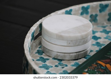 A stack of four, marble coasters.