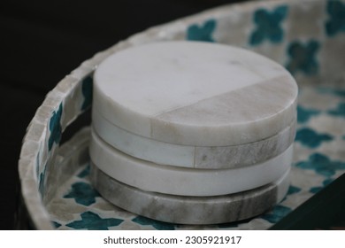 A stack of four, marble coasters.
