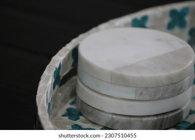 A stack of four, marble coasters.