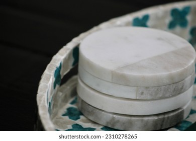 A stack of four, marble coasters.