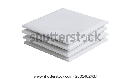 Stack of four square white ceramic tiles with smooth matte finish
