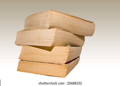 Stack Of Four Well Worn Paperback Novels Against Sun Faded Background