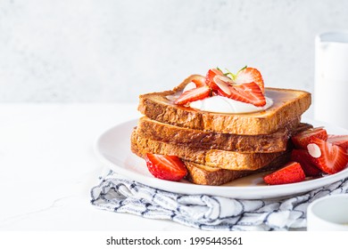 Stack of French toast with strawberries, yogurt and maple syrup, copy space. Breakfast concept. - Powered by Shutterstock