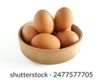 Stack of fresh chicken egg in basket wicker bamboo. Isolated on white background with copy space. Suitable for editing and used for food and nutrition advertising. 