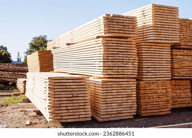 Stack of fresh pine boards in a sawmill warehouse. Harvesting, sale of lumber for construction	