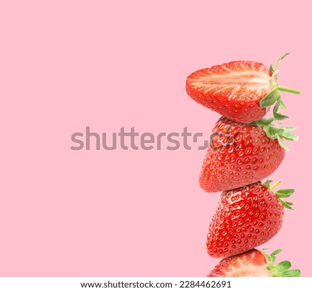 Stack of fresh strawberries on pink background, space for text