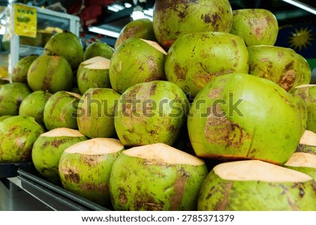 Stack of Fresh Young Green Coconuts at a Tropical Street Market Stall