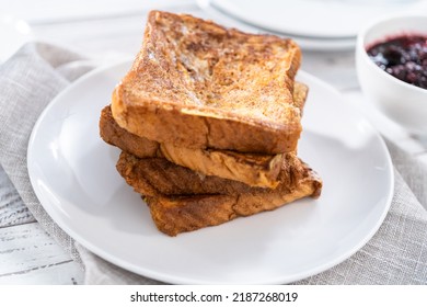 Stack Of Freshly Baked French Toast On A White Plate.