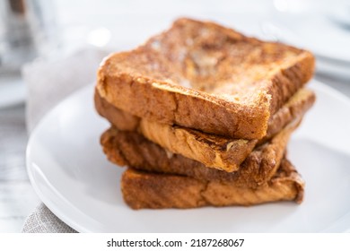 Stack Of Freshly Baked French Toast On A White Plate.