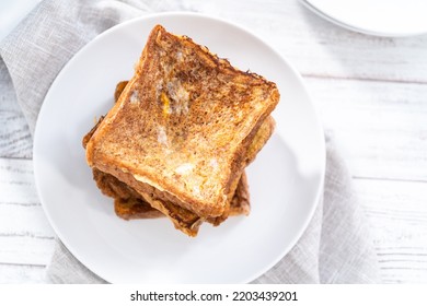 Stack Of Freshly Baked French Toast On A White Plate.